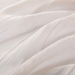texture of beige translucent fabric with soft longitudinal folds, macro