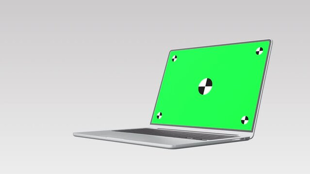 Realistic thin laptop computer 3d animation. Highly detailed metallic notebook open cover with green screen on white background. Zoom in display with mark spot ready to track your own photo or video.