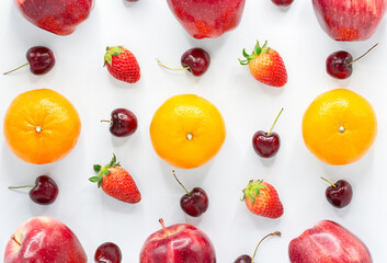 Colorful fruit pattern of fresh oranges on white background. strawberrys, apples and cherrys. Top view.