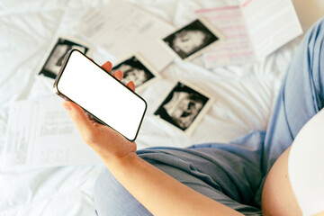 Pregnancy smartphone mockup. Pregnant woman holding smartphone. Mobile pregnancy online maternity application mock up. Concept of pregnancy, maternity, expectation for baby birth.