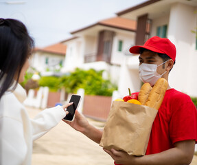 The shipper wears a mask, delivery food to the home of the online buyer. The sender has a service...