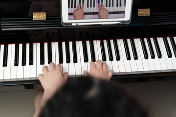 kid hands play piano key