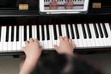 kid hands play piano key