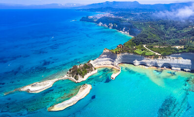 Ionian islands of Greece. Corfu aerial drone view of stunning Cape Drastis - natural beuty landscape with white rocks and turquoise waters, northern part of Corfu island. - obrazy, fototapety, plakaty