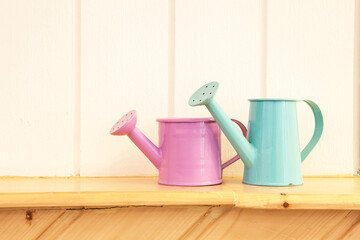 Watering can place on wooden shelf use for decoration © molpix