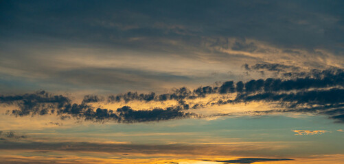 Tropical dawn sky with clouds in golden hues