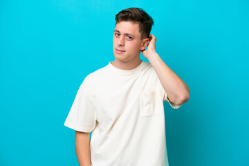 Young handsome Brazilian man isolated on blue background having doubts