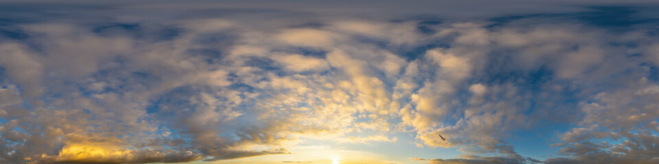 Panorama of a dark blue sunset sky with golden Cumulus clouds. Seamless hdr 360 panorama in spherical equiangular format. Full zenith for 3D visualization, sky replacement for aerial drone panoramas.