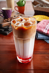 A glass of healthy fresh RED VELVET COFFEE isolated on wooden background side view