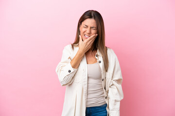 Middle age caucasian woman isolated on pink background with toothache