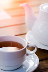 Cup of tea with teapot on wood table cafe