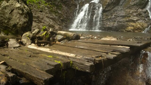 ancient wooden bridge near the waterfall Mervisi waterfall, near Batumi, Georgia, aerial shot. High quality 4k footage