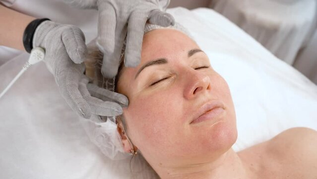 Electric micro-current procedure with conductive gloves. Anti-age, face lifting.