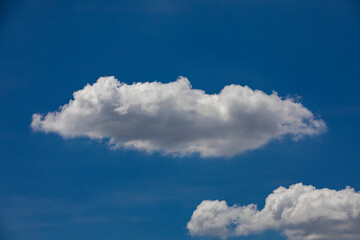Naklejka na ściany i meble Random shape of cloud on clear blue sky