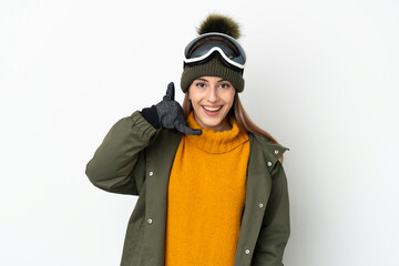 Skier caucasian woman with snowboarding glasses isolated on white background making phone gesture. Call me back sign