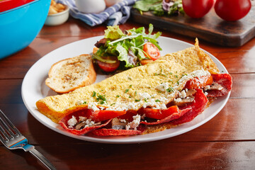 The Godfather omelette roll with salad served in a dish isolated on wooden background side view