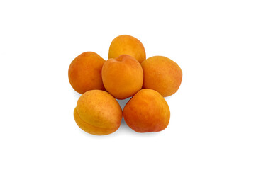 several small yellow apricots on a white background