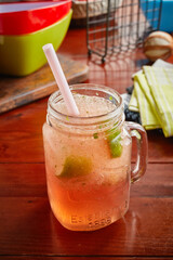 A jar of healthy fresh WATERMELON juice isolated on wooden background side view