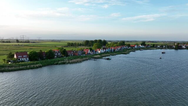 Durgerdam local dyke village with old traditional wooden houses in the north of Amsterdam. Harbour maritime countryside aerial landscape at sunset. Dutch Holland landscape.