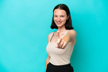 Fototapeta na wymiar Young caucasian woman isolated on blue background showing and lifting a finger