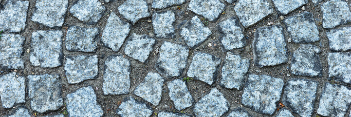 Panoramic image. Circular old cobblestones. Sidewalk made of gray stones
