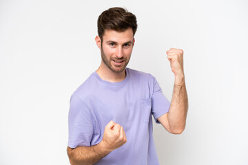 Young caucasian man isolated on white background celebrating a victory