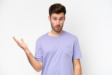 Young caucasian man isolated on white background making doubts gesture