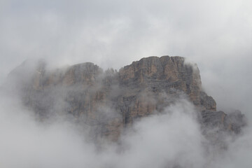 Mountain massif inside dense fog, Dolomites, Italy.