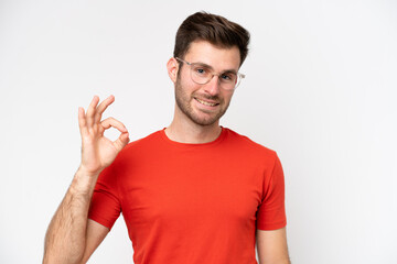 Young caucasian man isolated on white background With glasses and doing OK sign