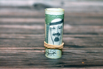 50 SAR fifty Saudi riyals cash money banknote bills rolled up with rubber bands with the photo of...