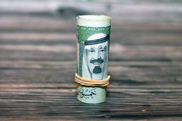 50 SAR fifty Saudi riyals cash money banknote bills rolled up with rubber bands with the photo of...