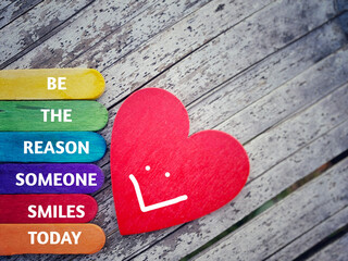 BE THE REASON SOMEONE SMILES TODAY text written on wooden colourful sticks. Inspirational Quote. Stock photo.
