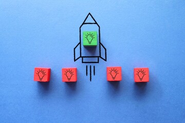Cube with idea lightbulb took off on rocket. Developing startup, best idea. Business accelerator. - obrazy, fototapety, plakaty
