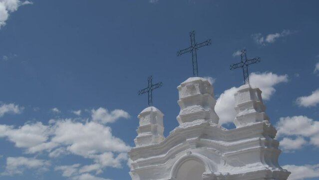 Three crosses in a vicar altar a sunny day with clouds passing