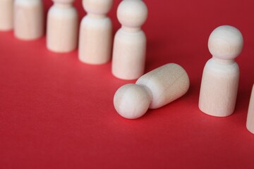 Wooden doll fall out of row line. Moral and physical exhaustion, stress, burnout at work concept.