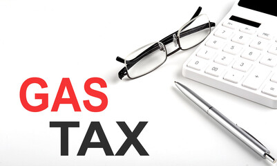 GAS TAX Concept. Calculator,pen and glasses on the white background