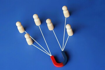Magnet attracts employee candidates dolls. Hiring staff. Find best talent, Human resources concept