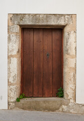Fototapeta na wymiar Old, picturesque main front door in mediterranean region house.
