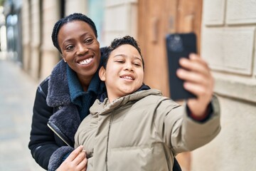 African american mother and son smiling confident make selfie by the smartphone at street