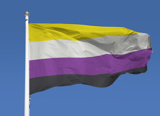 Closeup of a non binary pride flag in the sky