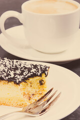 Fresh baked cheesecake and cup of coffee with milk. Delicious dessert
