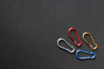 4mm climbing carabiner isolated against a dark background