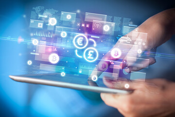 Close-up of a hand using tablet, currency concept