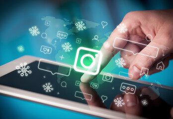 Close-up of a hand using tablet, social media concept
