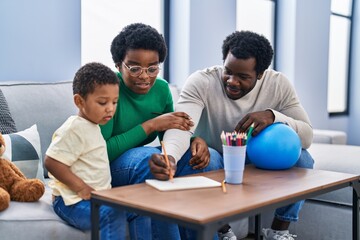 African american family drawing on notebook at home