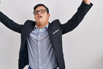 Young hispanic man with down syndrome wearing business style celebrating mad and crazy for success...