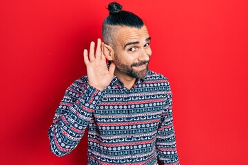 Young hispanic man wearing casual clothes smiling with hand over ear listening and hearing to rumor or gossip. deafness concept.