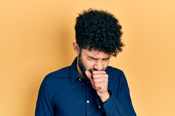 Fototapeta na wymiar Young arab man with beard wearing casual shirt feeling unwell and coughing as symptom for cold or bronchitis. health care concept.