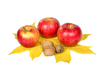 Apples and nuts on autumn maple leaves