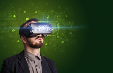 Businessman looking through Virtual Reality glasses, social media concept